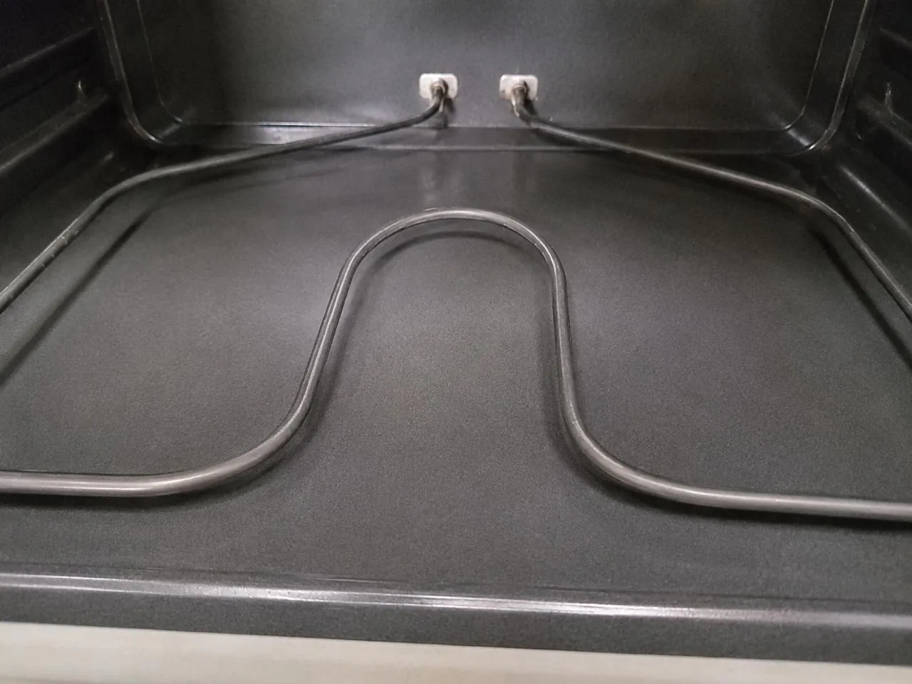 Clean oven interior with an intact bake element after repair