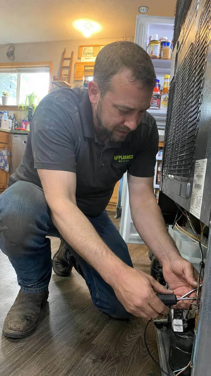 Escondido Appliance Repair technician servicing a refrigerator in a home kitchen